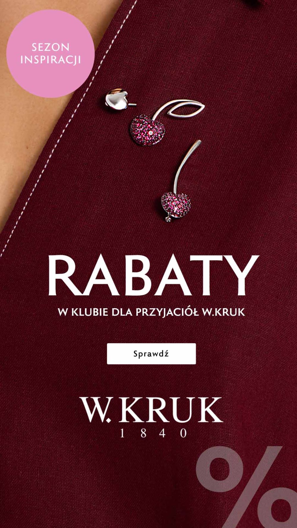 Biżuteria z motywem wiśni na bordowej tkaninie i napis „Sezon inspiracji – rabaty w Klubie dla Przyjaciół W.KRUK”.